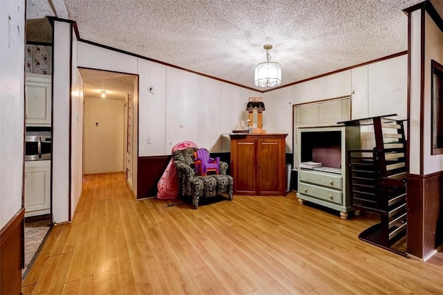 living area with light hardwood / wood-style flooring and a textured ceiling