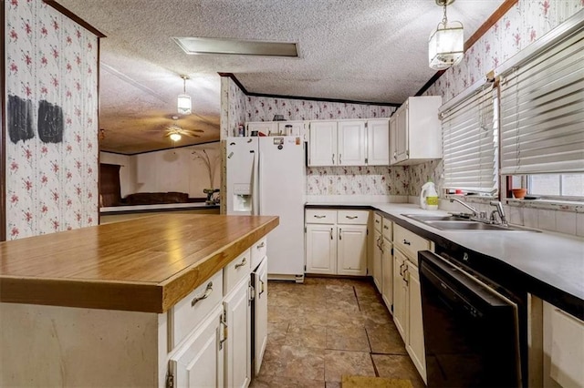 kitchen featuring pendant lighting, vaulted ceiling, black dishwasher, and sink