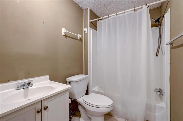 bathroom featuring vanity, a textured ceiling, tile flooring, and toilet