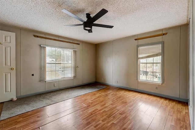 unfurnished room featuring ceiling fan, a textured ceiling, and light hardwood / wood-style floors