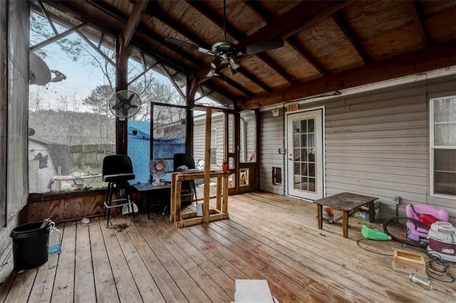 sunroom with lofted ceiling with beams, a healthy amount of sunlight, wooden ceiling, and ceiling fan