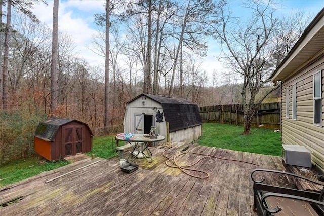 deck featuring a yard and a storage unit