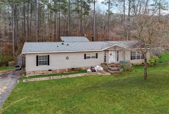 rear view of property featuring a lawn