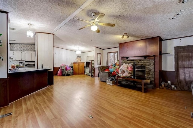 interior space featuring ceiling fan and a fireplace