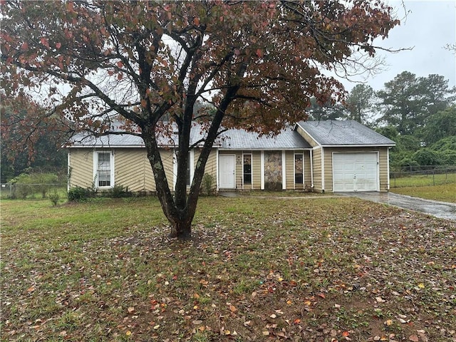 single story home featuring a garage and a front lawn