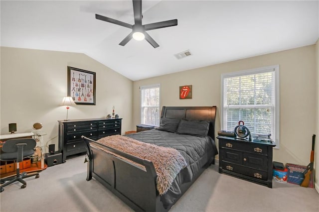 carpeted bedroom with vaulted ceiling, visible vents, and a ceiling fan