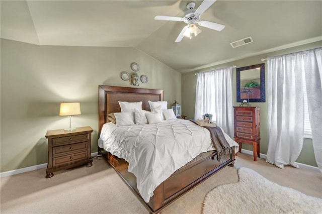 bedroom with visible vents, vaulted ceiling, light carpet, and baseboards