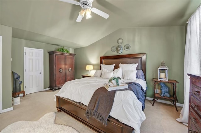 bedroom featuring light carpet, ceiling fan, baseboards, and vaulted ceiling