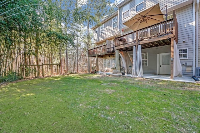 view of yard featuring a deck, central AC, and a patio area