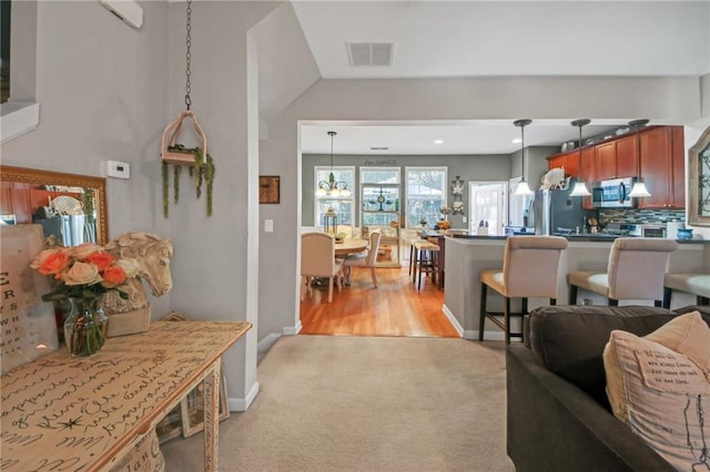 interior space with light carpet, baseboards, and visible vents