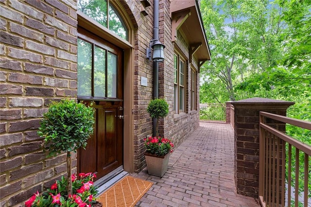 doorway to property with brick siding