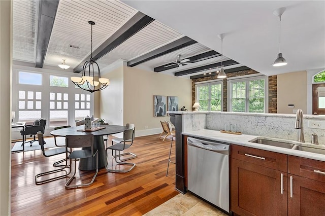 kitchen featuring brown cabinetry, a sink, dishwasher, and beamed ceiling