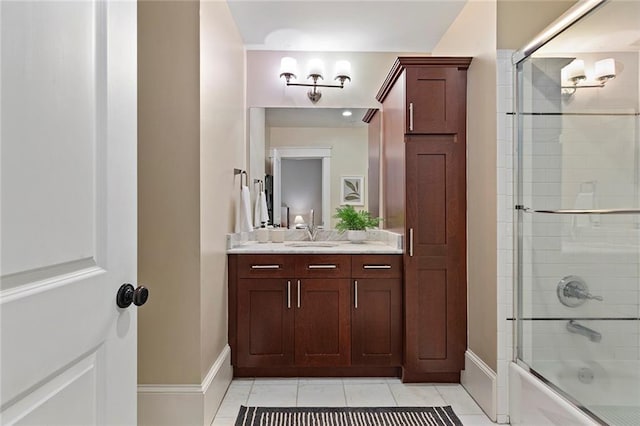 bathroom featuring shower / bath combination with glass door, baseboards, tile patterned floors, and vanity