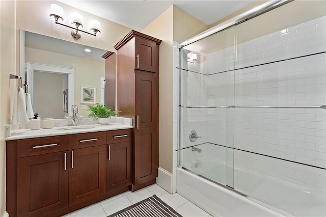 bathroom with vanity, baseboards, enclosed tub / shower combo, and tile patterned flooring