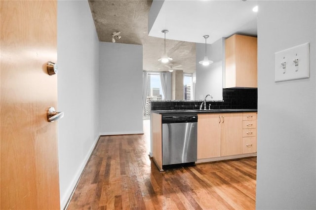 860 Peachtree St NE Unit 909, Atlanta, GA 30308 - kitchen with stainless steel dishwasher, a sink, light brown cabinetry, dark countertops, and wood finished floors