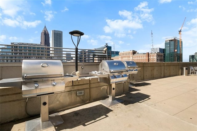 860 Peachtree St NE Unit 909, Atlanta, GA 30308 - view of patio / terrace with grilling area and a view of skyline