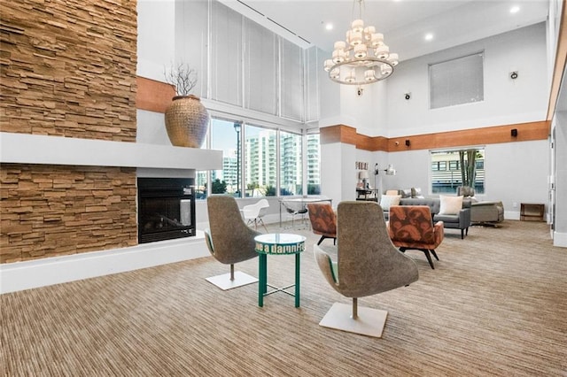 860 Peachtree St NE Unit 909, Atlanta, GA 30308 - carpeted living area with a multi sided fireplace, a chandelier, a high ceiling, recessed lighting, and baseboards