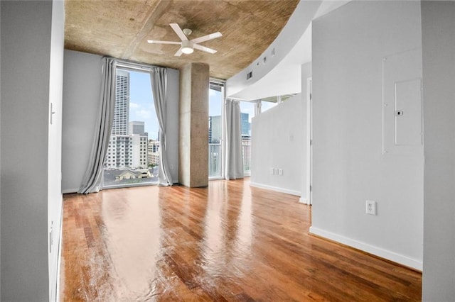 860 Peachtree St NE Unit 909, Atlanta, GA 30308 - unfurnished room featuring wood finished floors, a ceiling fan, baseboards, and a city view