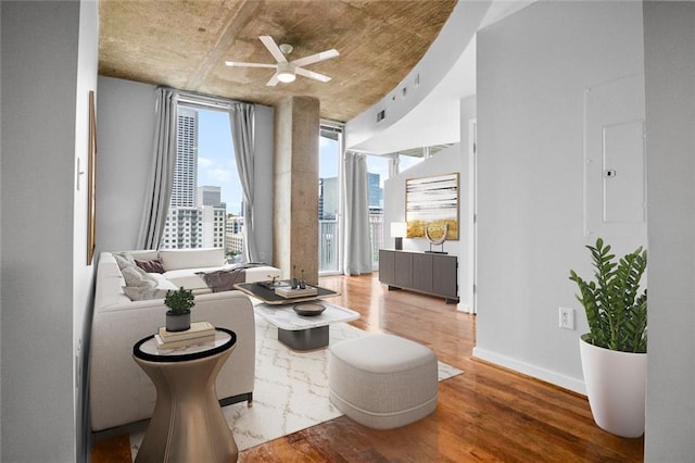 860 Peachtree St NE Unit 909, Atlanta, GA 30308 - living area with wood finished floors, ceiling fan, baseboards, and a city view