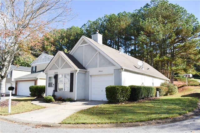 view of front of home with a garage and a front lawn