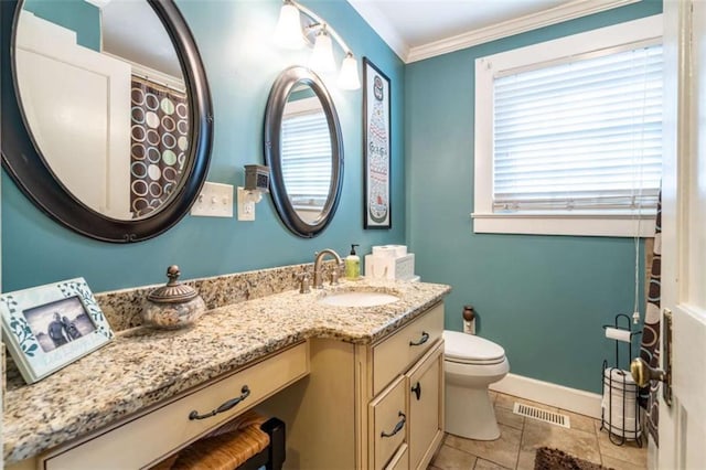 full bathroom featuring toilet, vanity, baseboards, visible vents, and crown molding