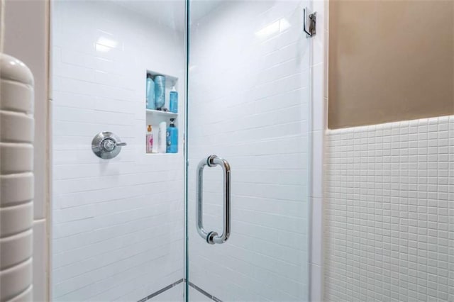 full bath with a shower stall