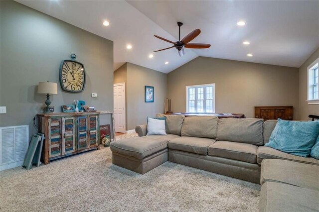 living area with lofted ceiling, a wealth of natural light, carpet, and visible vents