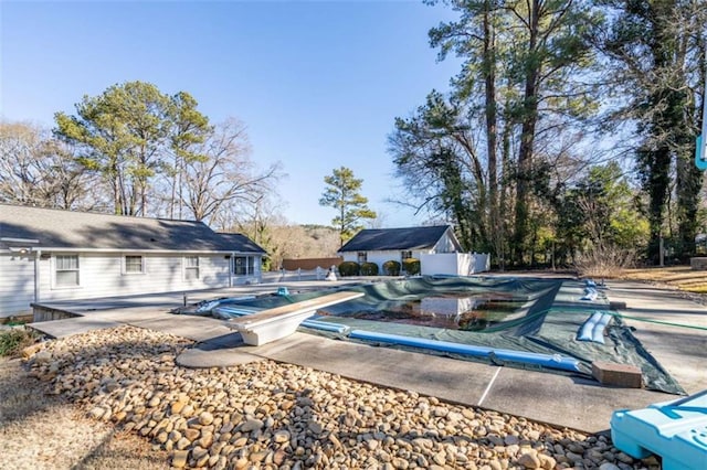 view of pool featuring a patio, fence, and a covered pool