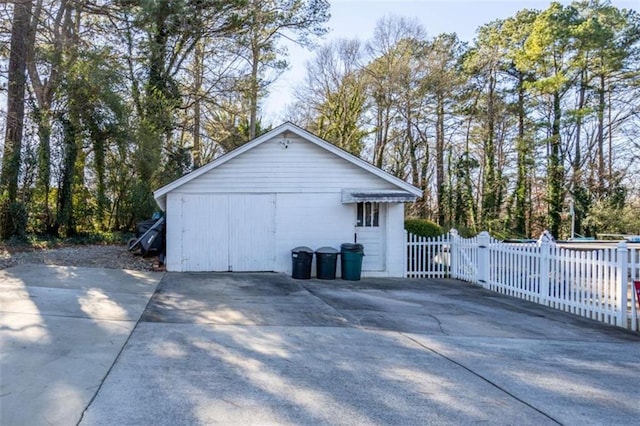 garage with a gate and fence