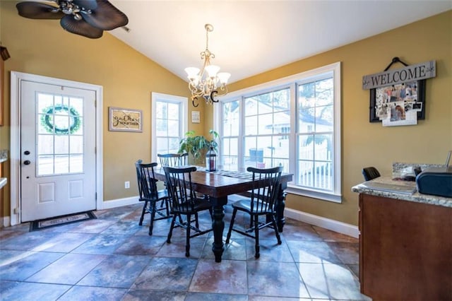 dining area with plenty of natural light, baseboards, vaulted ceiling, and ceiling fan with notable chandelier