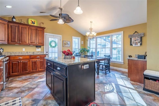 kitchen featuring vaulted ceiling, visible vents, plenty of natural light, and decorative light fixtures