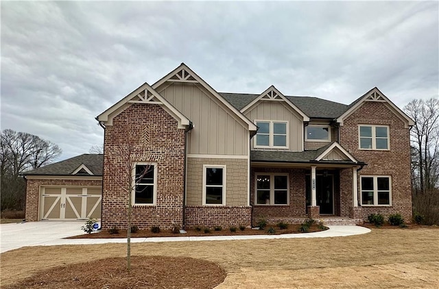 4020 Sierra Knolls Ct, Cumming, GA 30040 - craftsman-style house with brick siding, board and batten siding, a porch, a front yard, and driveway