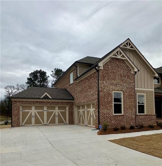 4020 Sierra Knolls Ct, Cumming, GA 30040 - view of home's exterior featuring brick siding, board and batten siding, and driveway
