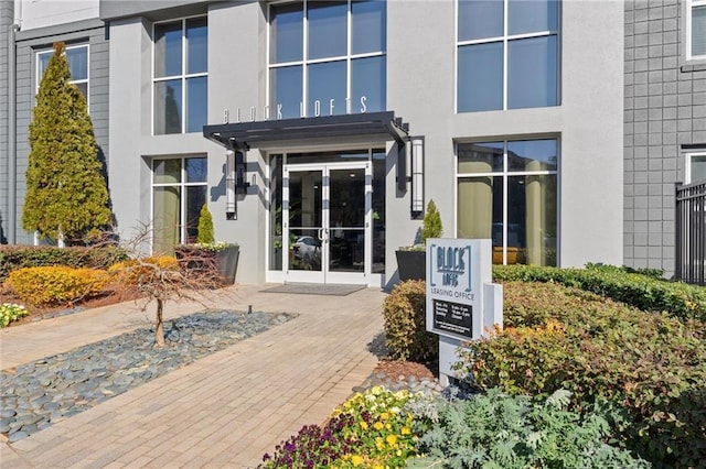 doorway to property with stucco siding and french doors