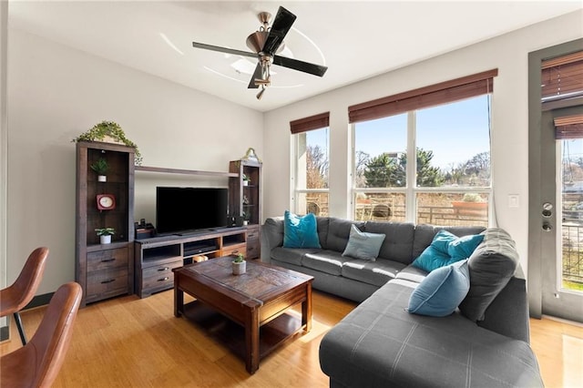 living area featuring ceiling fan and light wood finished floors