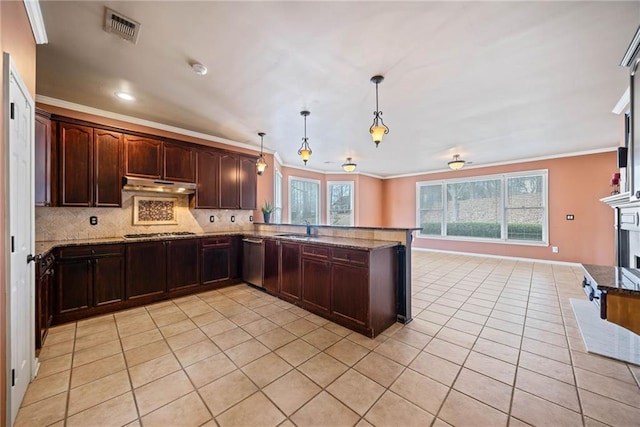 kitchen featuring sink, decorative light fixtures, kitchen peninsula, decorative backsplash, and appliances with stainless steel finishes