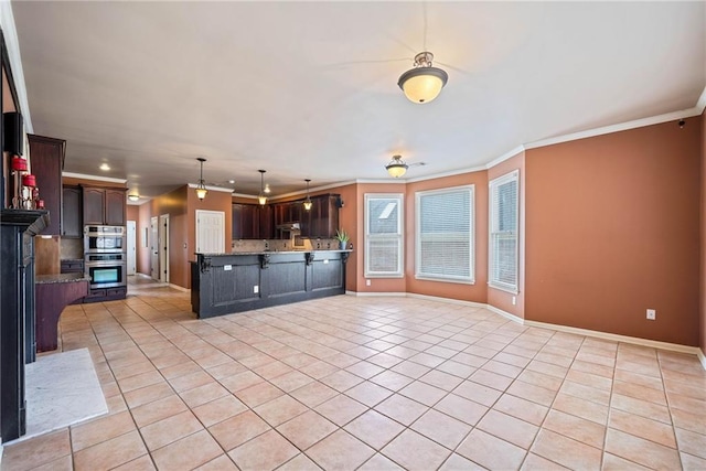 kitchen featuring light tile patterned flooring, stainless steel double oven, dark brown cabinetry, pendant lighting, and crown molding