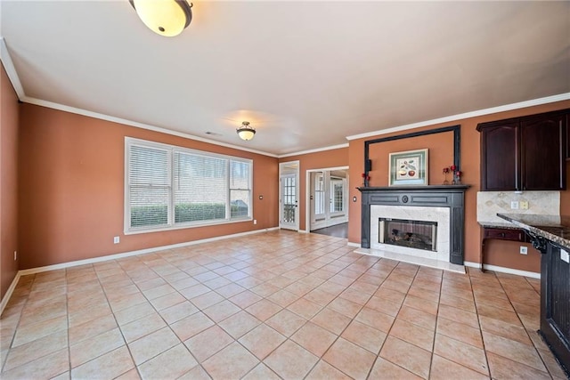 unfurnished living room with crown molding and light tile patterned floors