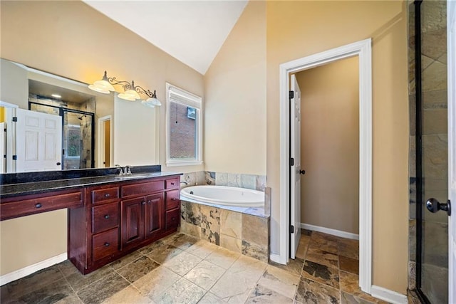 bathroom featuring plus walk in shower, vaulted ceiling, and vanity