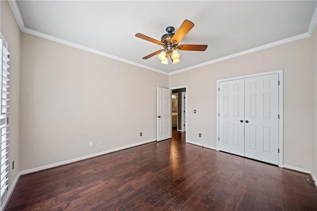 unfurnished bedroom with ceiling fan, a closet, dark hardwood / wood-style floors, multiple windows, and crown molding