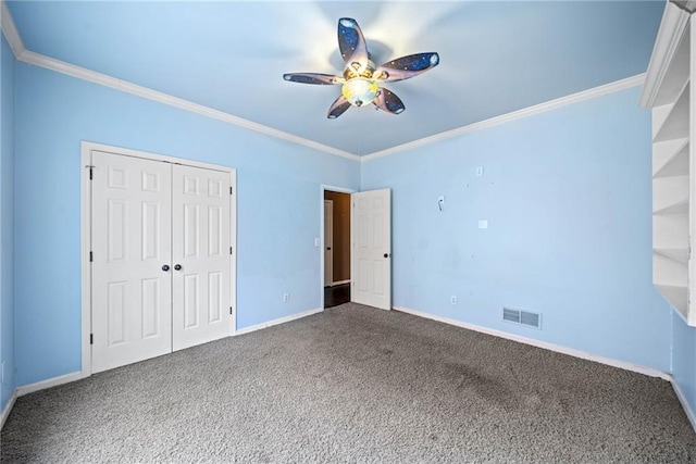 unfurnished bedroom featuring carpet flooring, a closet, ceiling fan, and crown molding