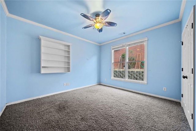 carpeted empty room with ornamental molding, ceiling fan, and built in features