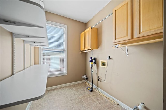 laundry room with washer hookup, plenty of natural light, and cabinets