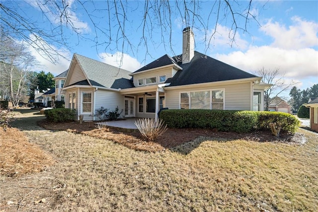 back of house with a patio and a yard