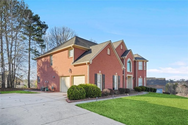 view of side of property with a garage and a lawn