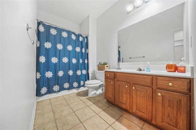 bathroom featuring toilet, vanity, and tile patterned floors