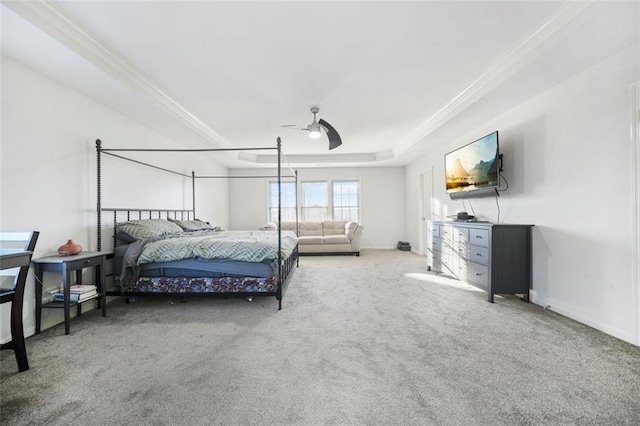 bedroom featuring a tray ceiling, ceiling fan, carpet, and ornamental molding