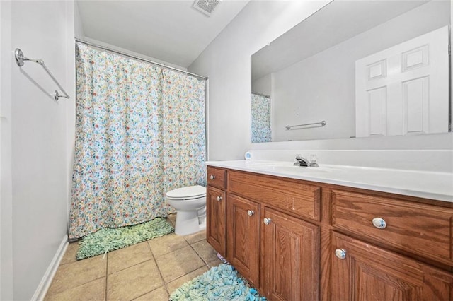 bathroom featuring tile patterned flooring, vanity, and toilet