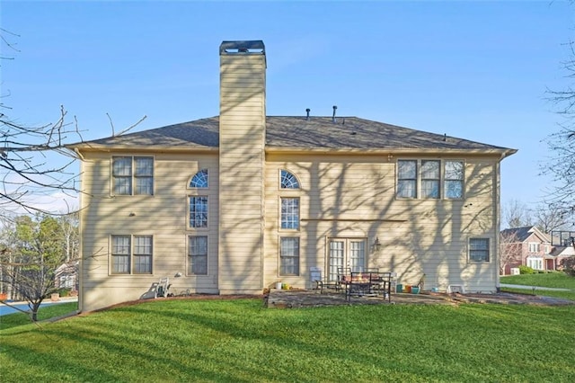 rear view of house with a lawn and a patio area