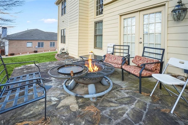 view of patio / terrace with french doors and a fire pit